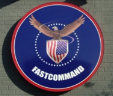 Picture of our FastCommand logo outside of the FastHealth/FastCommand building. It is a circle with an eagle standing above the American Flag and there is stars forming a circle around the eagle. It says:
FASTCOMMAND